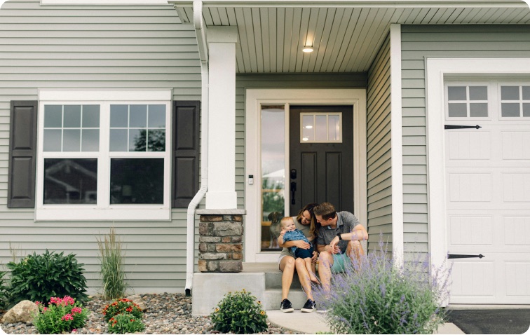 Family standing in front of their new home